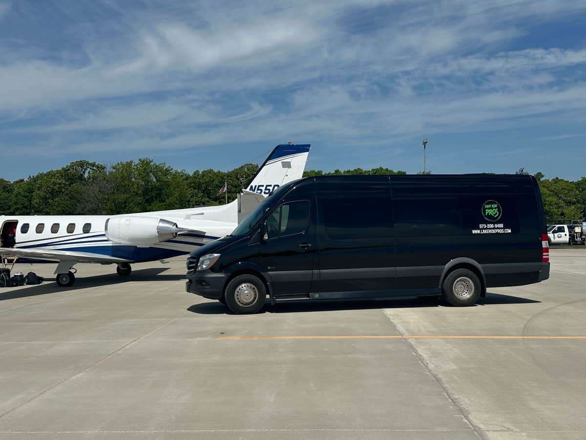 Lake Ride Pros Executive Sprinter parked beside a private aircraft